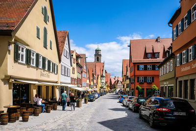 Street amidst buildings against sky in city