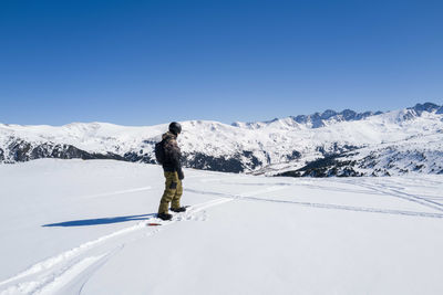 Man snowboarding off piste slope