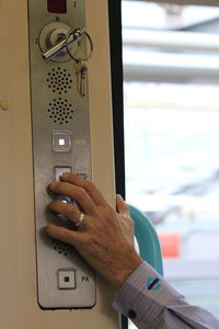 Close-up of man pressing button in train