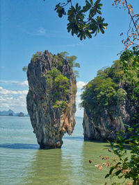 Scenic view of rocks in sea against sky