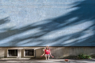 Full length of woman with arms raised