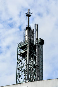 Low angle view of communications tower against sky