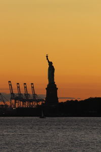 Silhouette of statue at sunset