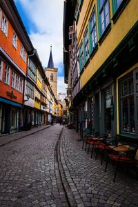 Street amidst buildings against sky in city