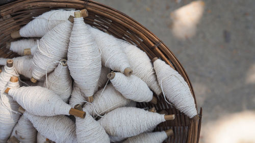 Directly above shot of white threads in basket