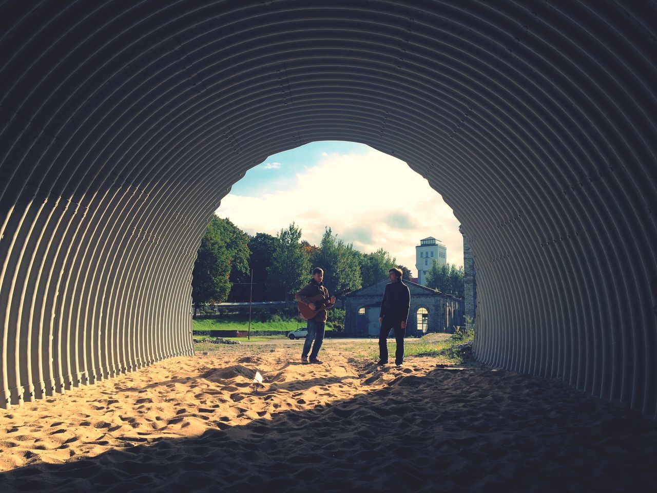 full length, walking, men, lifestyles, in a row, diminishing perspective, sky, rear view, person, leisure activity, the way forward, cobblestone, tree, walkway, togetherness, tunnel, footpath, child, cloud - sky, day, pedestrian walkway, pathway, arched, casual clothing, outdoors, arch