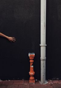 Close-up of hand against blue wall