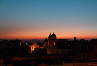 Silhouette of building against sky during sunset