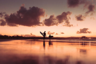 Silhouette woman walking on lake