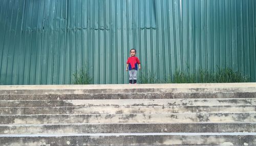 Full length of red steps in water