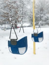 Close-up of swing on snow covered field