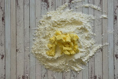 Directly above shot of fresh white flowers on table against wall