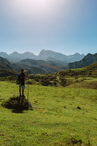 Man standing on mountain against sky