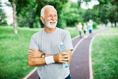 Portrait of man standing at public park