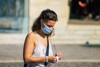 Young woman using mobile phone outdoors