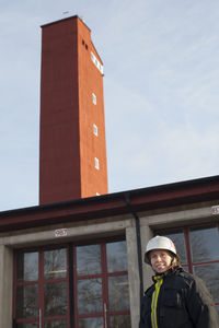 Female firefighter in front of fire station