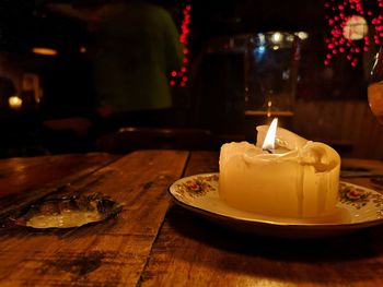 Close-up of lit candles on table