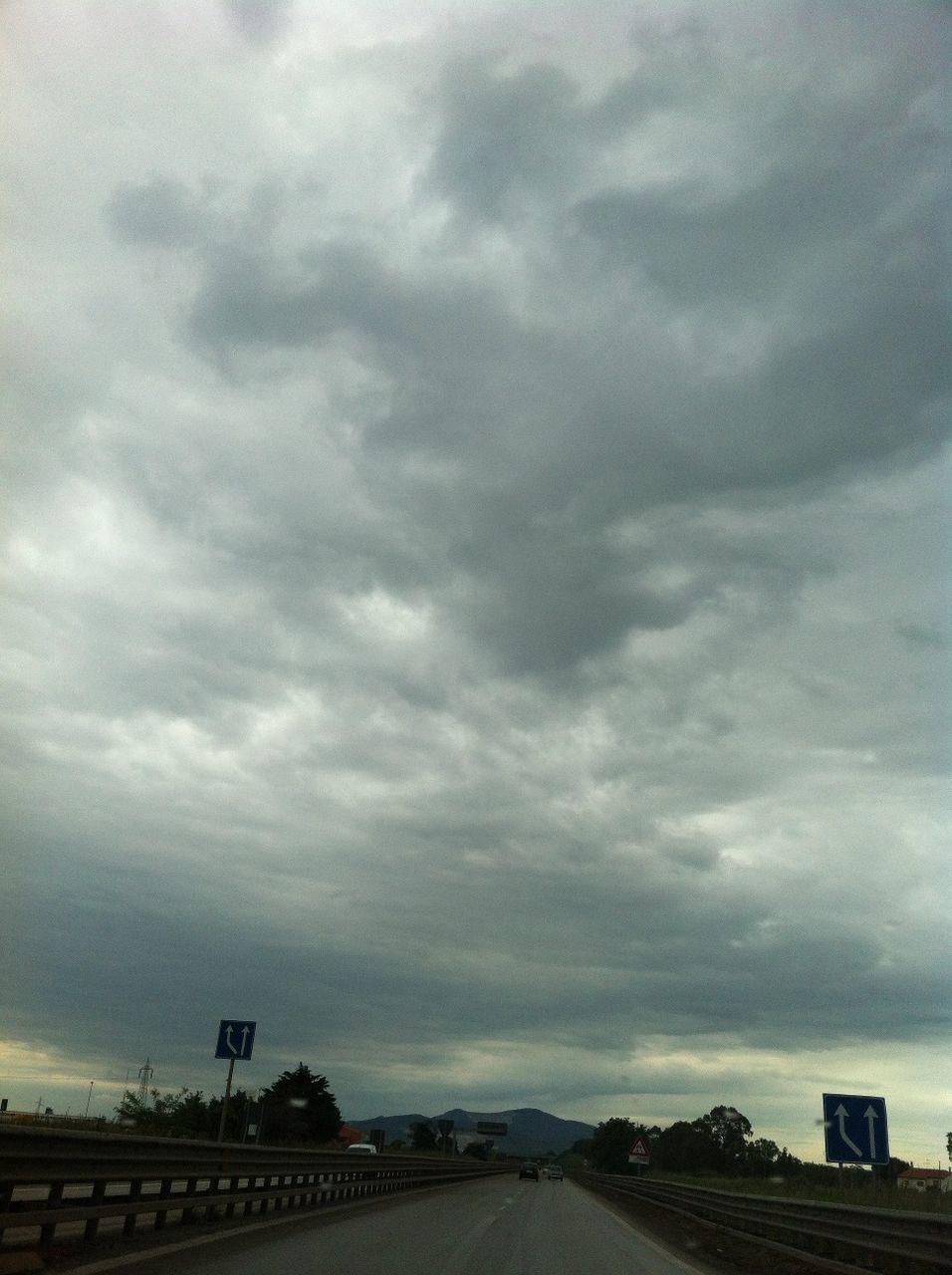 sky, cloud - sky, cloudy, the way forward, overcast, weather, built structure, architecture, road, transportation, storm cloud, cloud, building exterior, diminishing perspective, vanishing point, dramatic sky, street, nature, outdoors, cloudscape