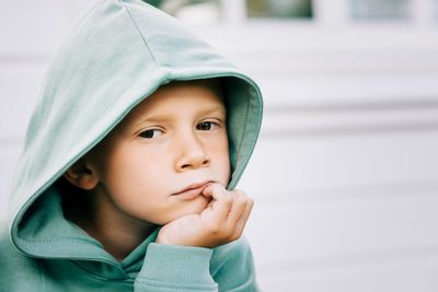 Close up portrait of a boy with his hood up