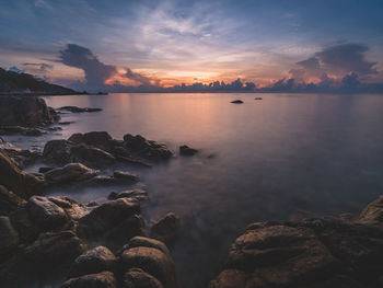 Island's dawn view at rocky bay with colorful sky. long exposure, blurred wave. koh samui, thailand.