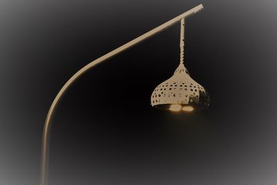 Close-up of illuminated lamp against black background