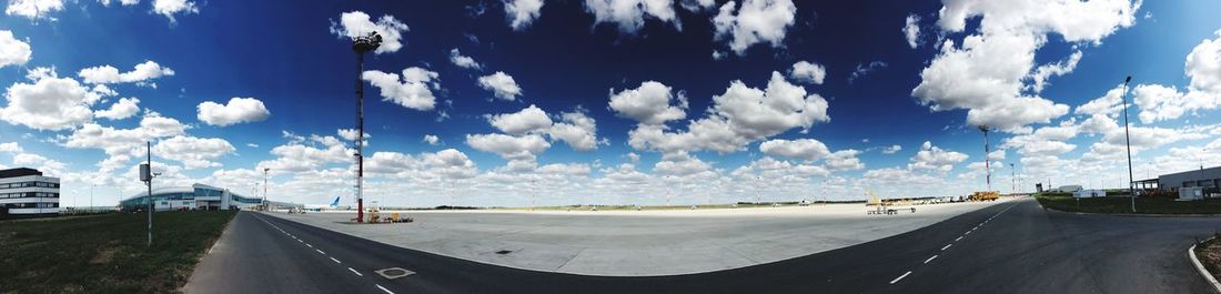 Panoramic view of city street against sky