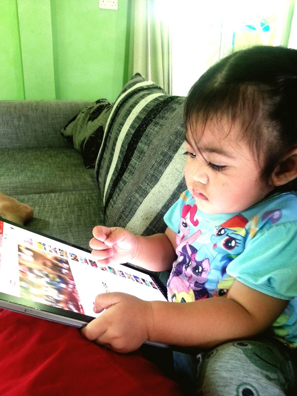 PORTRAIT OF GIRL HOLDING TOY WHILE SITTING ON FLOOR