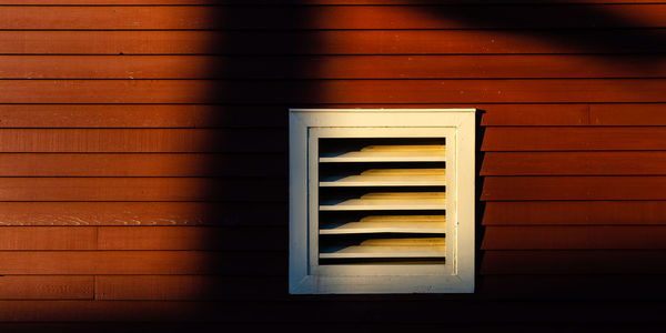 Close-up of window on wooden wall