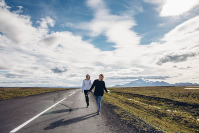 Man standing on road against mountain range