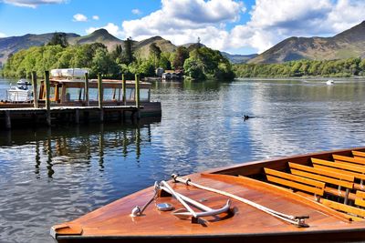 Boats moored in lake against sky