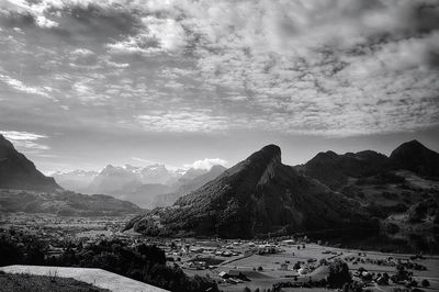 Scenic view of mountains against cloudy sky