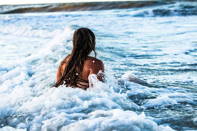 Rear view of woman in sea