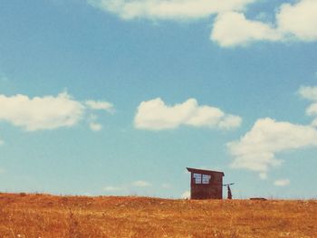 Built structure on field against sky