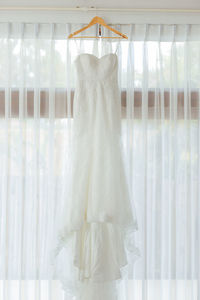 Wedding dress on bed at home