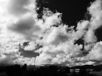 Low angle view of buildings against cloudy sky