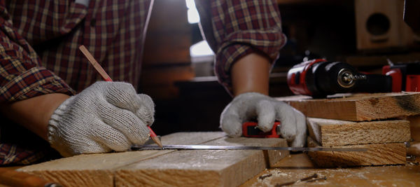 Low section of man working on table