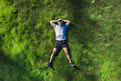 Portrait of man lying on grass