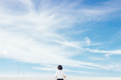 Rear view of woman against sky