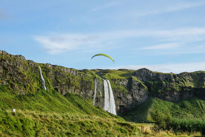 Low angle view of waterfall against sky