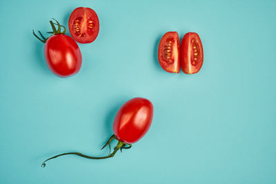 High angle view of tomatoes against blue background