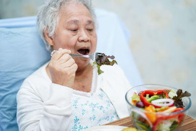 Midsection of woman eating ice cream