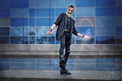 Digital composite image of man standing against wall in city