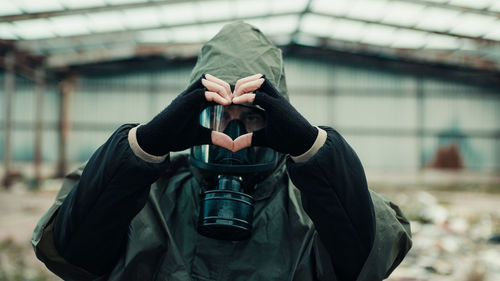 Soldier makes heart symbol with his hands