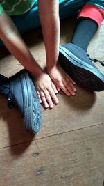 Low section of women sitting on floor