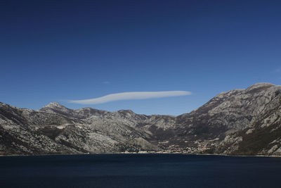 Scenic view of mountains against clear blue sky