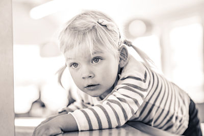 Portrait of cute boy sitting at home