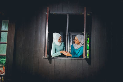 Couple sitting on window