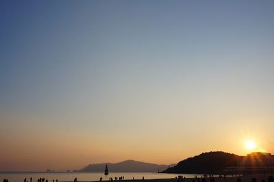 Scenic view of sea against clear sky during sunset