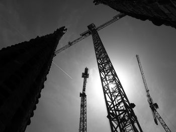 Low angle view of crane against sky