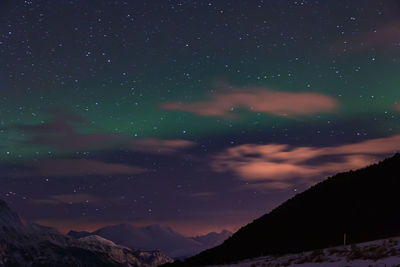 Low angle view of mountain against sky at night